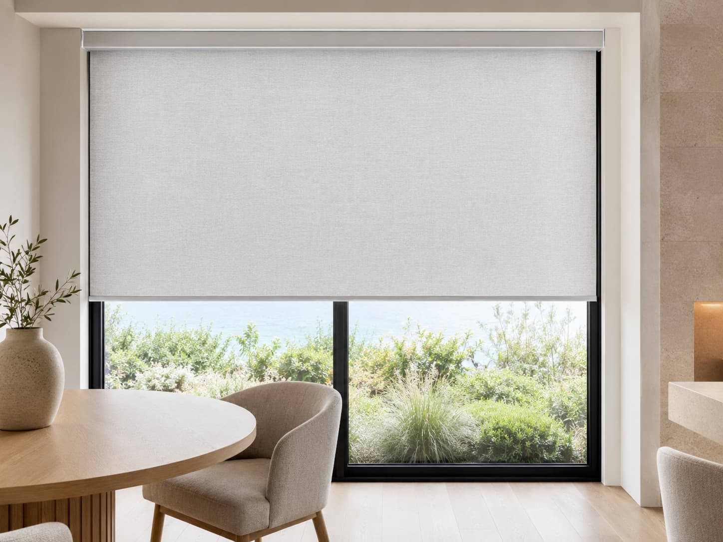 Roller shade lowered two-thirds over a bright living-room window