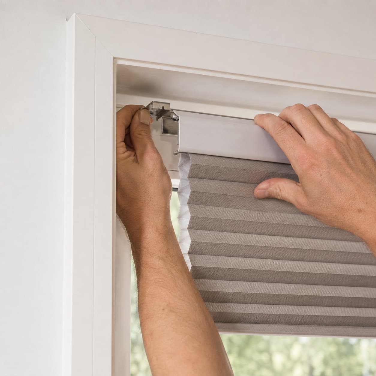 Installer fitting a cellular shade